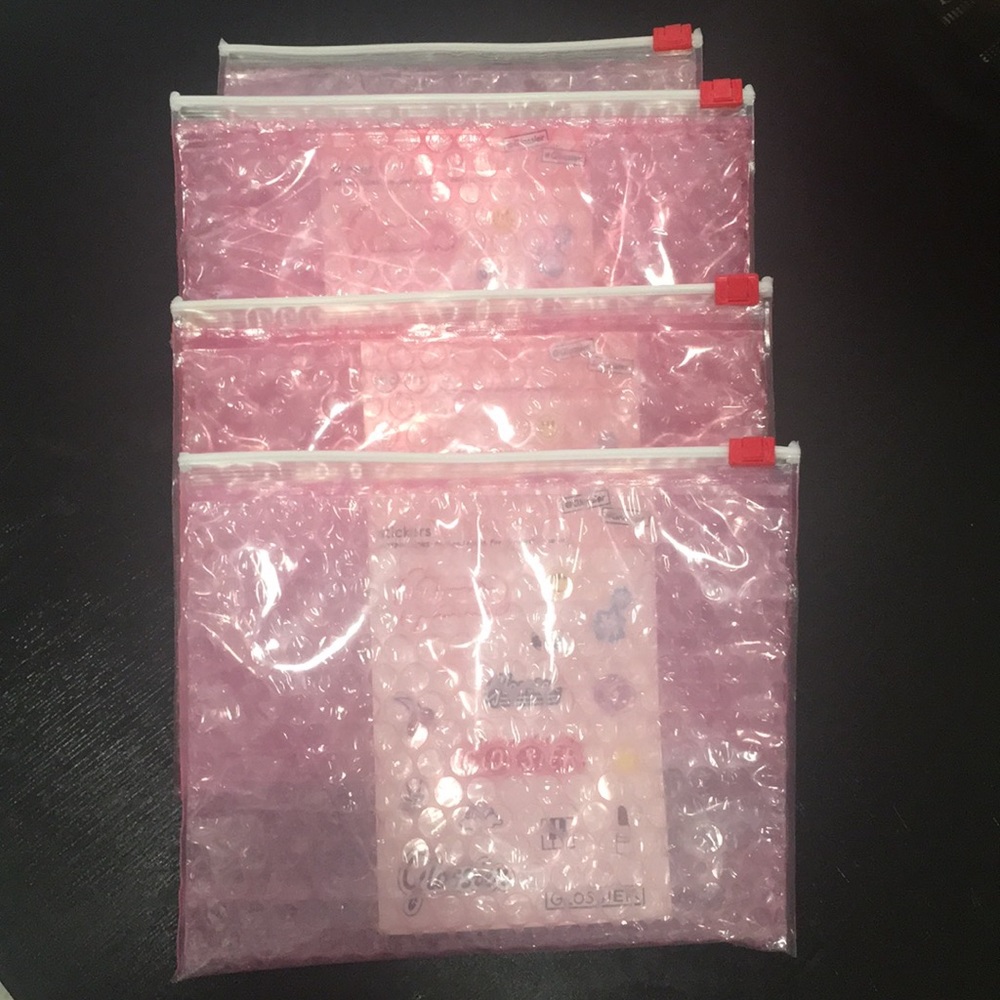 Glossier pink pouch with sticker sheet